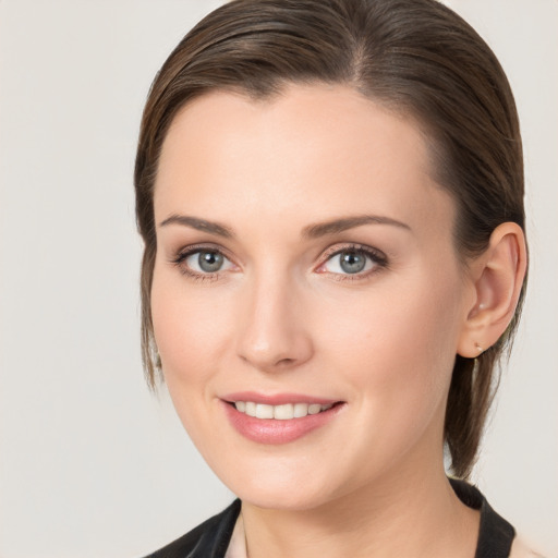 Joyful white young-adult female with medium  brown hair and blue eyes