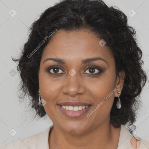 Joyful black adult female with long  brown hair and brown eyes