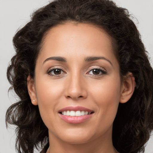 Joyful white young-adult female with long  brown hair and brown eyes