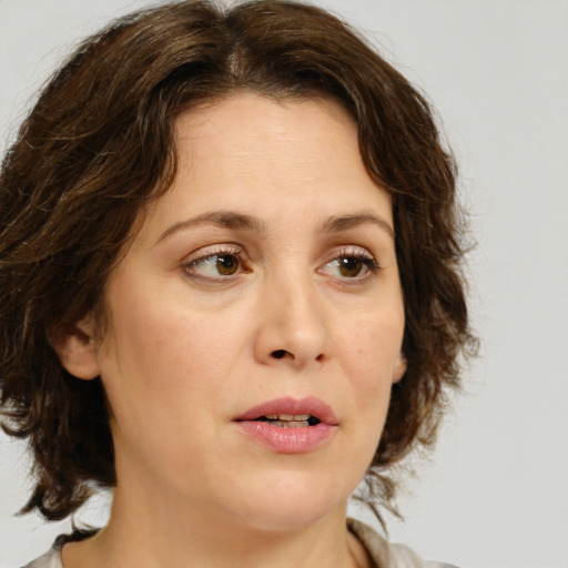 Joyful white young-adult female with medium  brown hair and green eyes