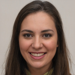 Joyful white young-adult female with long  brown hair and brown eyes