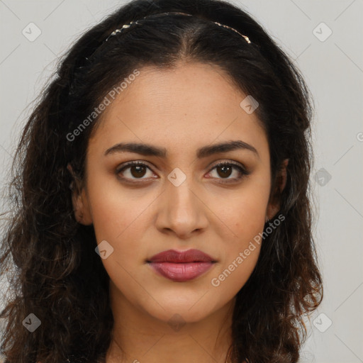 Joyful latino young-adult female with long  brown hair and brown eyes