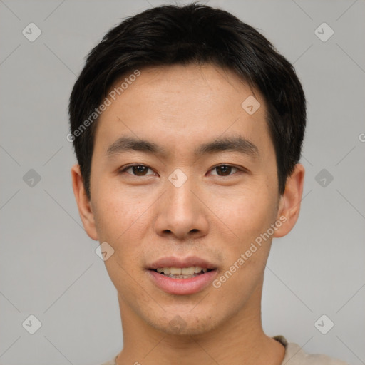 Joyful asian young-adult male with short  brown hair and brown eyes