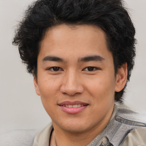 Joyful latino young-adult male with short  brown hair and brown eyes