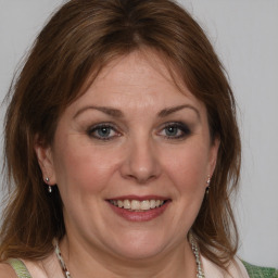 Joyful white adult female with medium  brown hair and brown eyes