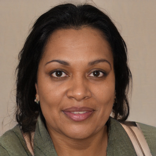 Joyful black adult female with medium  brown hair and brown eyes