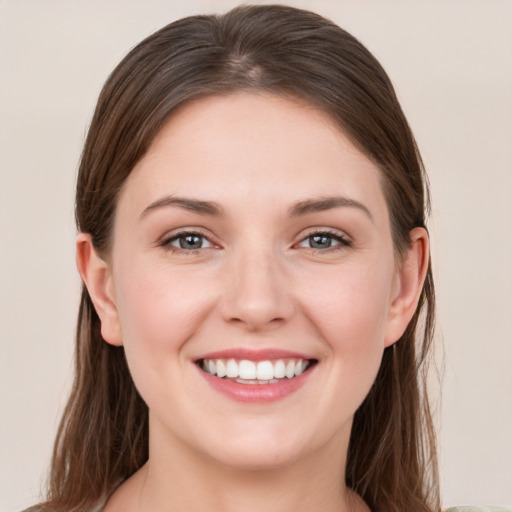 Joyful white young-adult female with long  brown hair and grey eyes