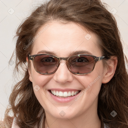 Joyful white young-adult female with long  brown hair and blue eyes