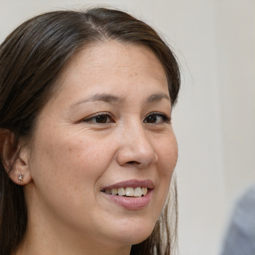 Joyful white adult female with medium  brown hair and brown eyes