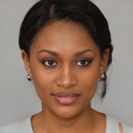 Joyful black young-adult female with medium  brown hair and brown eyes