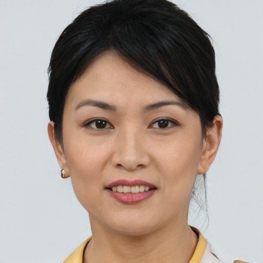 Joyful asian young-adult female with short  brown hair and brown eyes