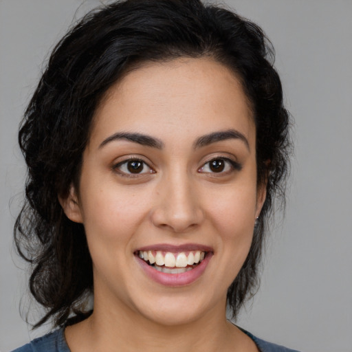 Joyful latino young-adult female with medium  black hair and brown eyes