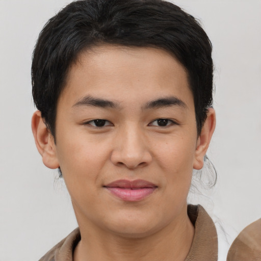 Joyful asian young-adult male with short  brown hair and brown eyes