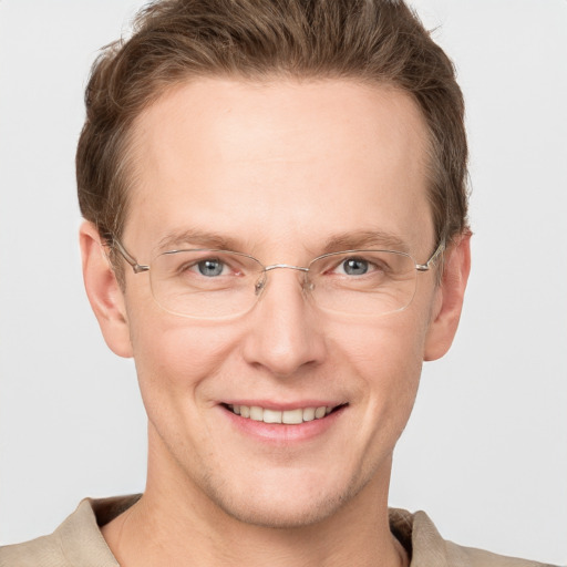 Joyful white adult male with short  brown hair and grey eyes