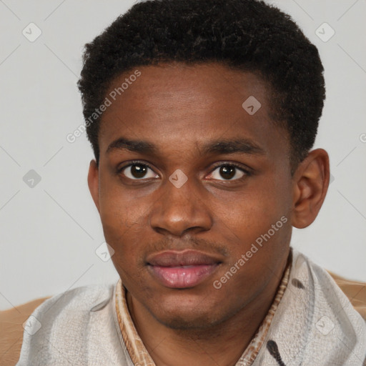 Joyful black young-adult male with short  brown hair and brown eyes