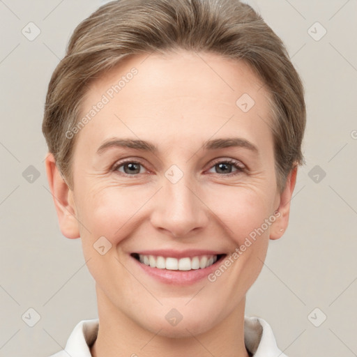 Joyful white young-adult female with short  brown hair and grey eyes