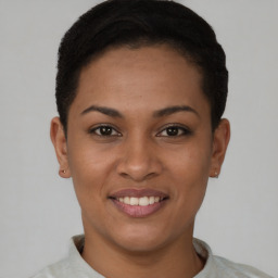 Joyful latino young-adult female with short  black hair and brown eyes