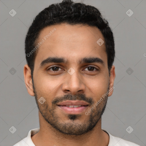 Joyful latino young-adult male with short  black hair and brown eyes