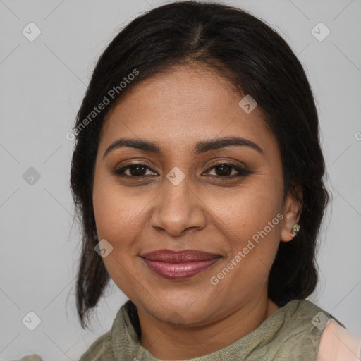 Joyful black adult female with medium  brown hair and brown eyes