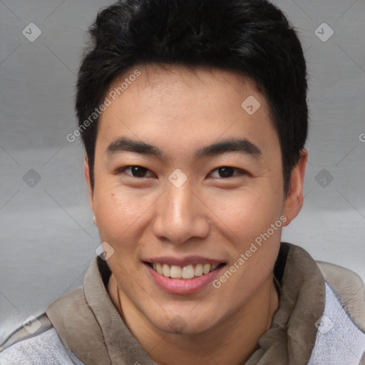 Joyful asian young-adult male with short  black hair and brown eyes