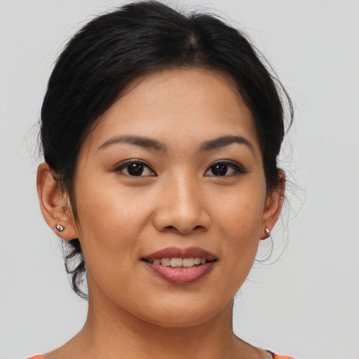 Joyful asian young-adult female with medium  brown hair and brown eyes