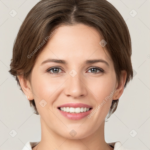 Joyful white young-adult female with short  brown hair and grey eyes