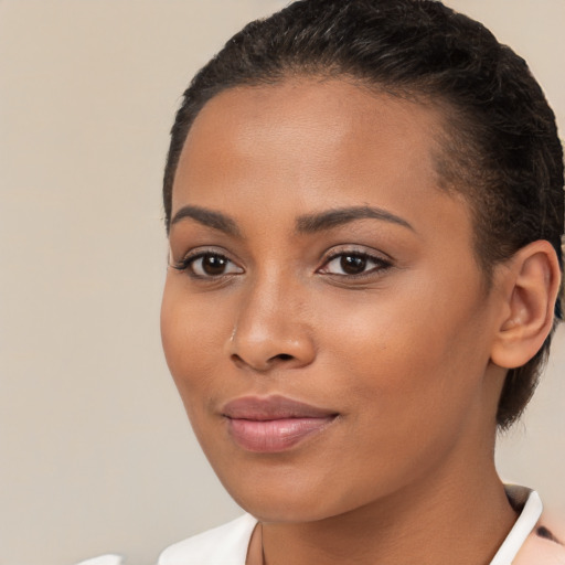 Joyful latino young-adult female with short  brown hair and brown eyes