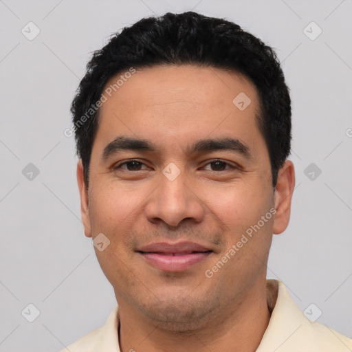 Joyful latino young-adult male with short  black hair and brown eyes