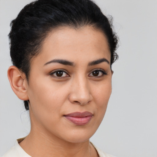 Joyful latino young-adult female with short  brown hair and brown eyes