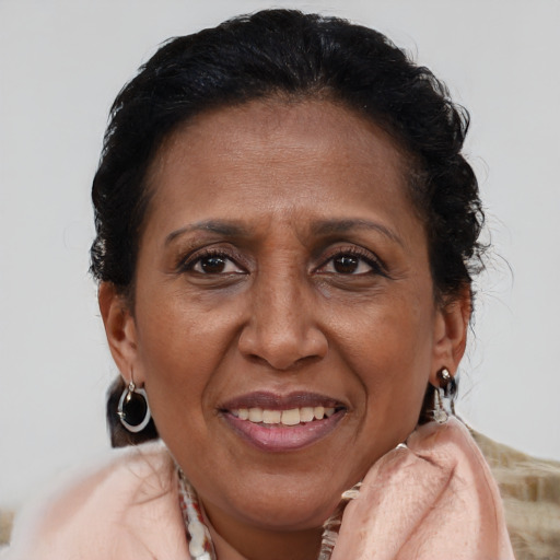 Joyful latino adult female with medium  brown hair and brown eyes