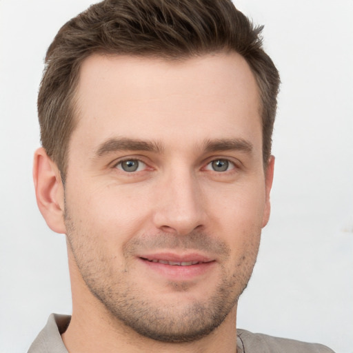 Joyful white young-adult male with short  brown hair and brown eyes