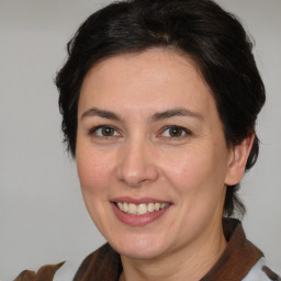 Joyful white adult female with medium  brown hair and brown eyes