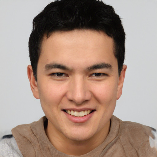 Joyful asian young-adult male with short  brown hair and brown eyes