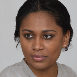 Joyful black young-adult female with medium  brown hair and brown eyes