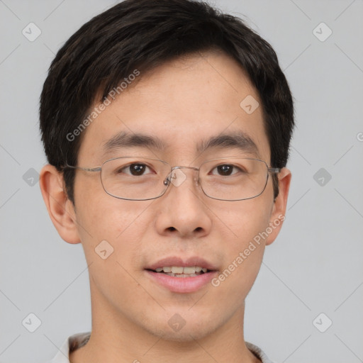 Joyful asian young-adult male with short  brown hair and brown eyes