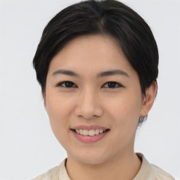 Joyful asian young-adult female with short  black hair and brown eyes