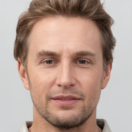 Joyful white adult male with short  brown hair and grey eyes