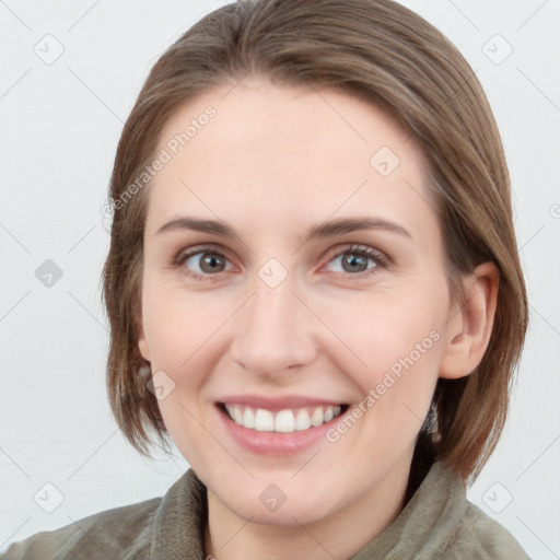 Joyful white young-adult female with medium  brown hair and blue eyes