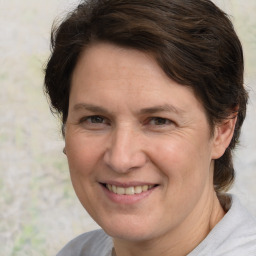 Joyful white adult female with medium  brown hair and brown eyes