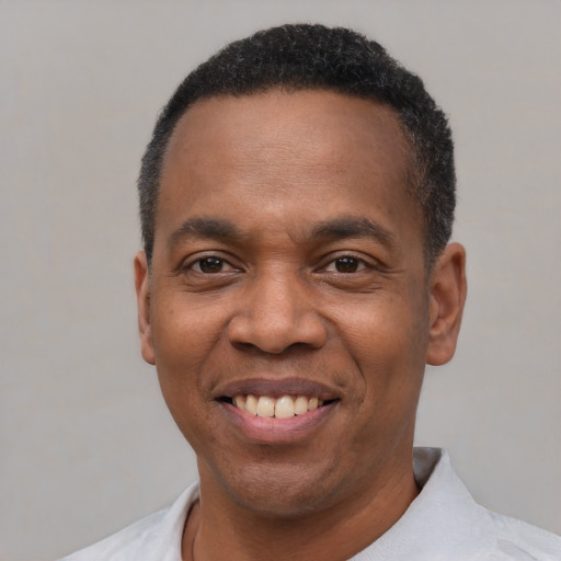 Joyful latino adult male with short  black hair and brown eyes