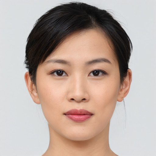 Joyful asian young-adult female with short  black hair and brown eyes