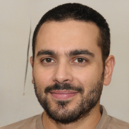Joyful white young-adult male with short  black hair and brown eyes