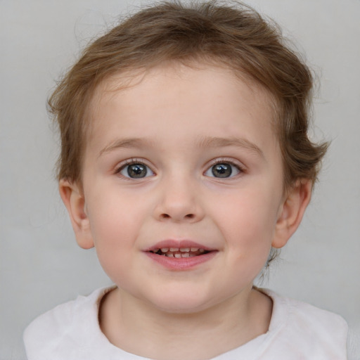 Joyful white child female with short  brown hair and blue eyes