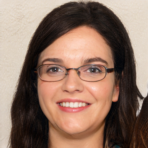 Joyful white adult female with long  brown hair and brown eyes