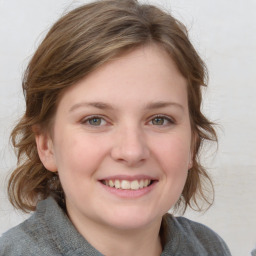 Joyful white young-adult female with medium  brown hair and blue eyes