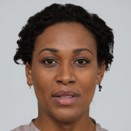 Joyful black adult female with short  black hair and brown eyes
