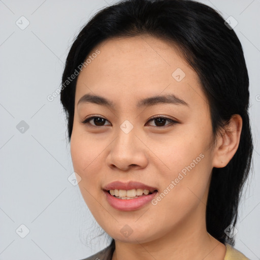 Joyful asian young-adult female with medium  black hair and brown eyes