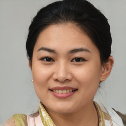 Joyful asian young-adult female with medium  brown hair and brown eyes