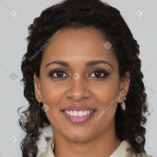 Joyful black young-adult female with long  black hair and brown eyes