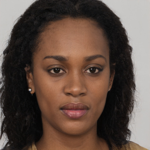 Neutral black young-adult female with long  brown hair and brown eyes